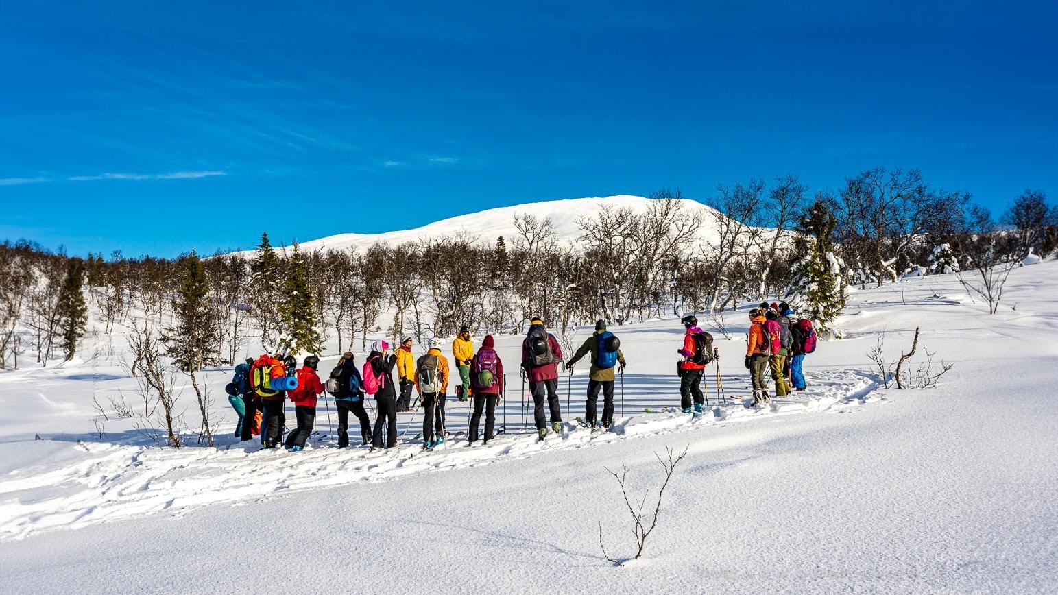 group of people in the winter mountains