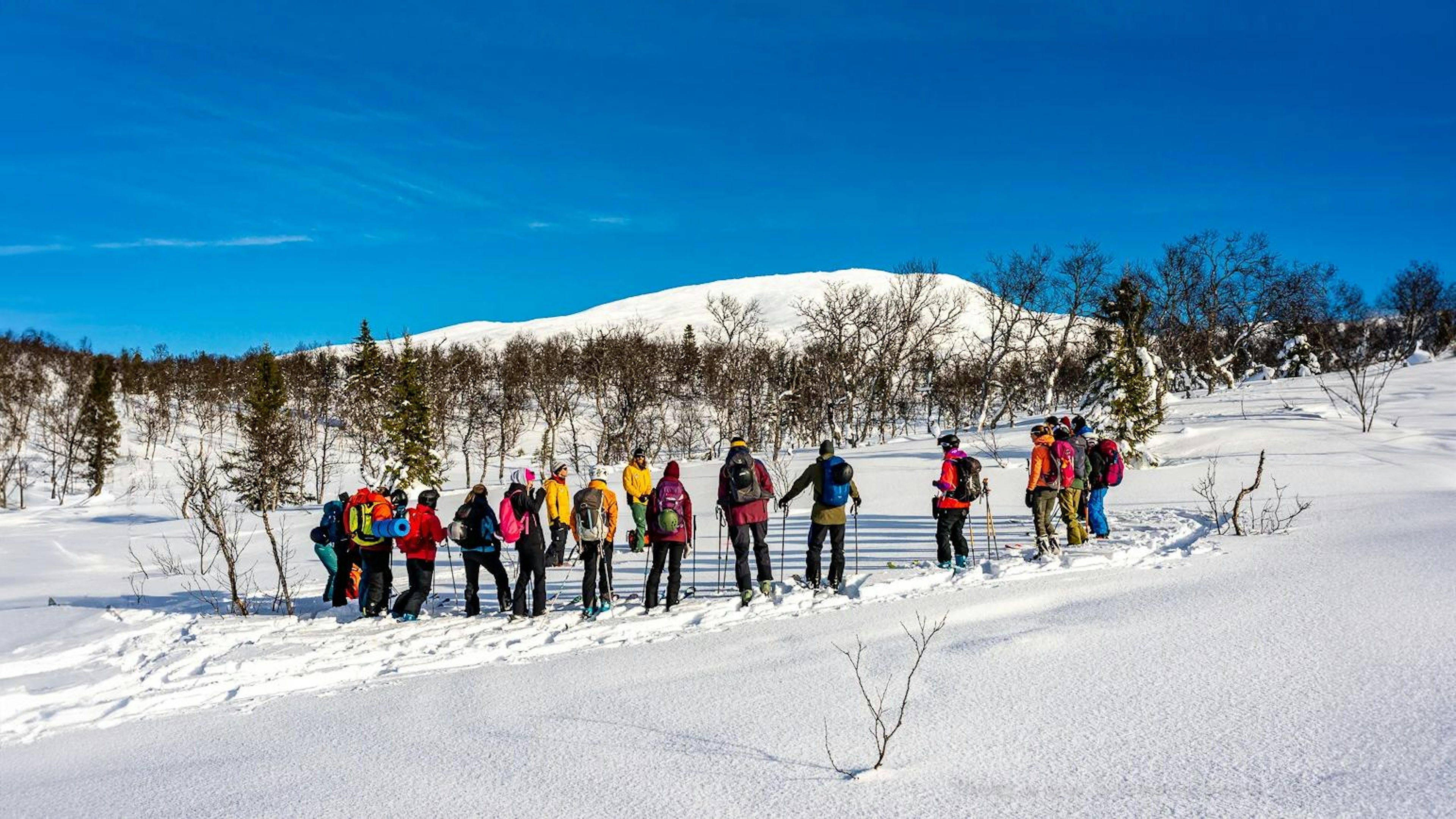 group of people in the winter mountains