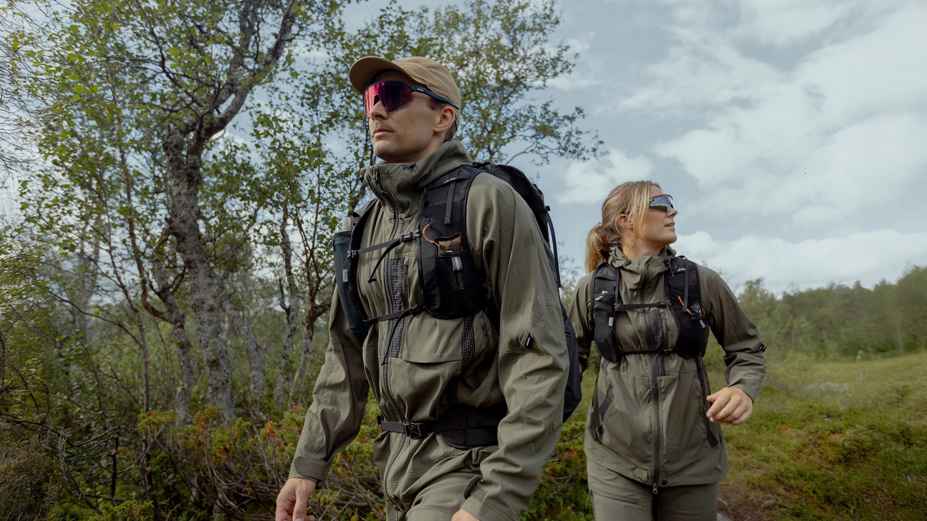 Women hiking in mountains with a dog