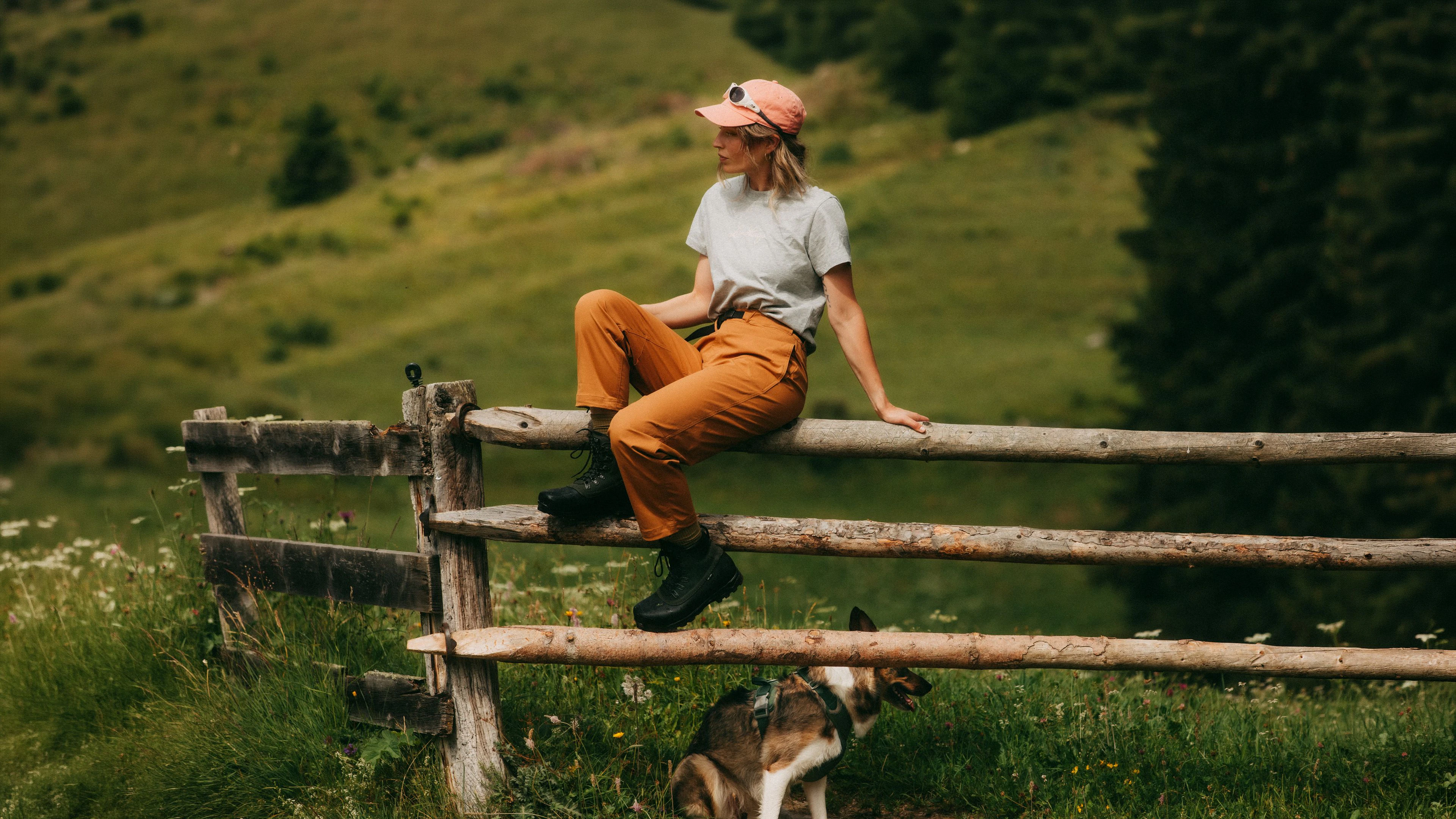 Women hiking in mountains with a dog