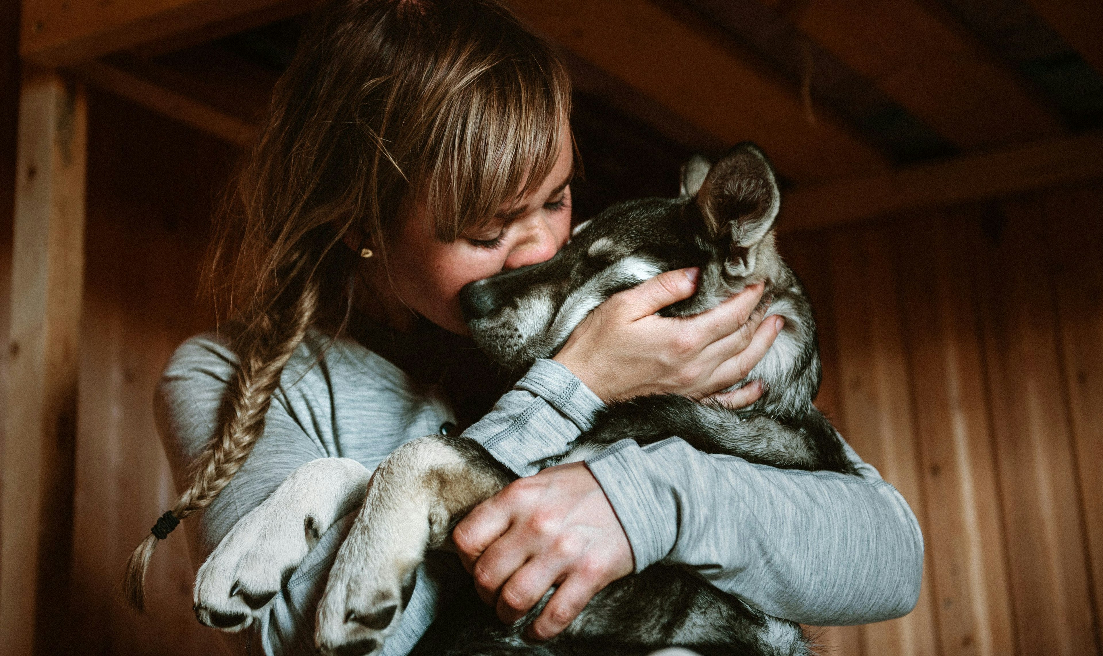 a woman hugging her dog