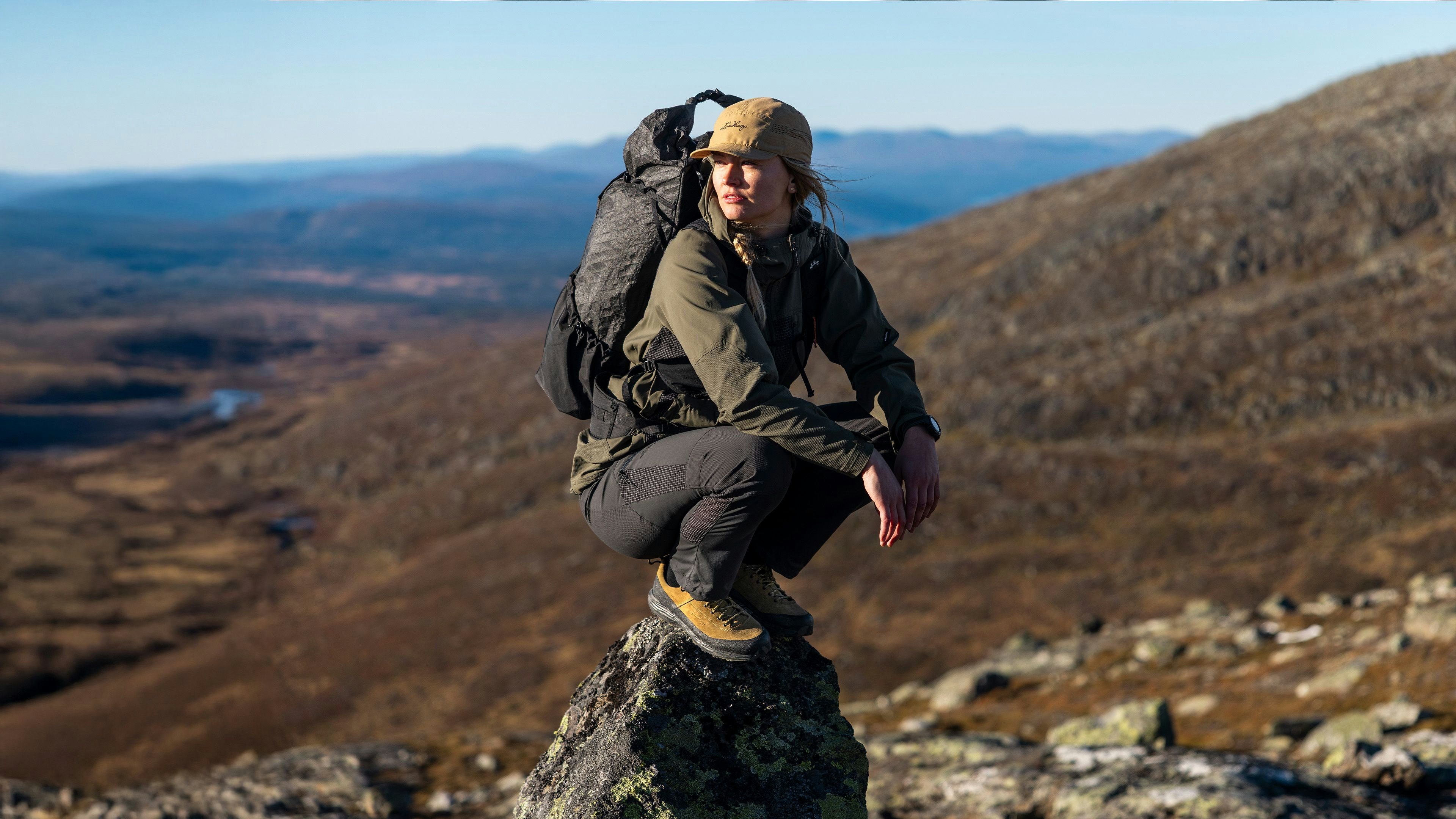 Woman hiking mountain with Padje Ultralight backpack