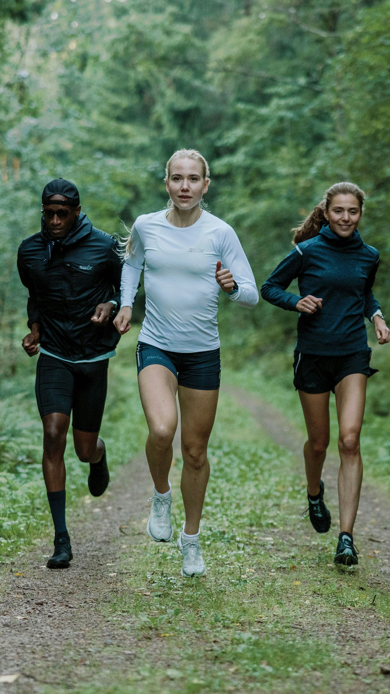 A group of people running in the woods