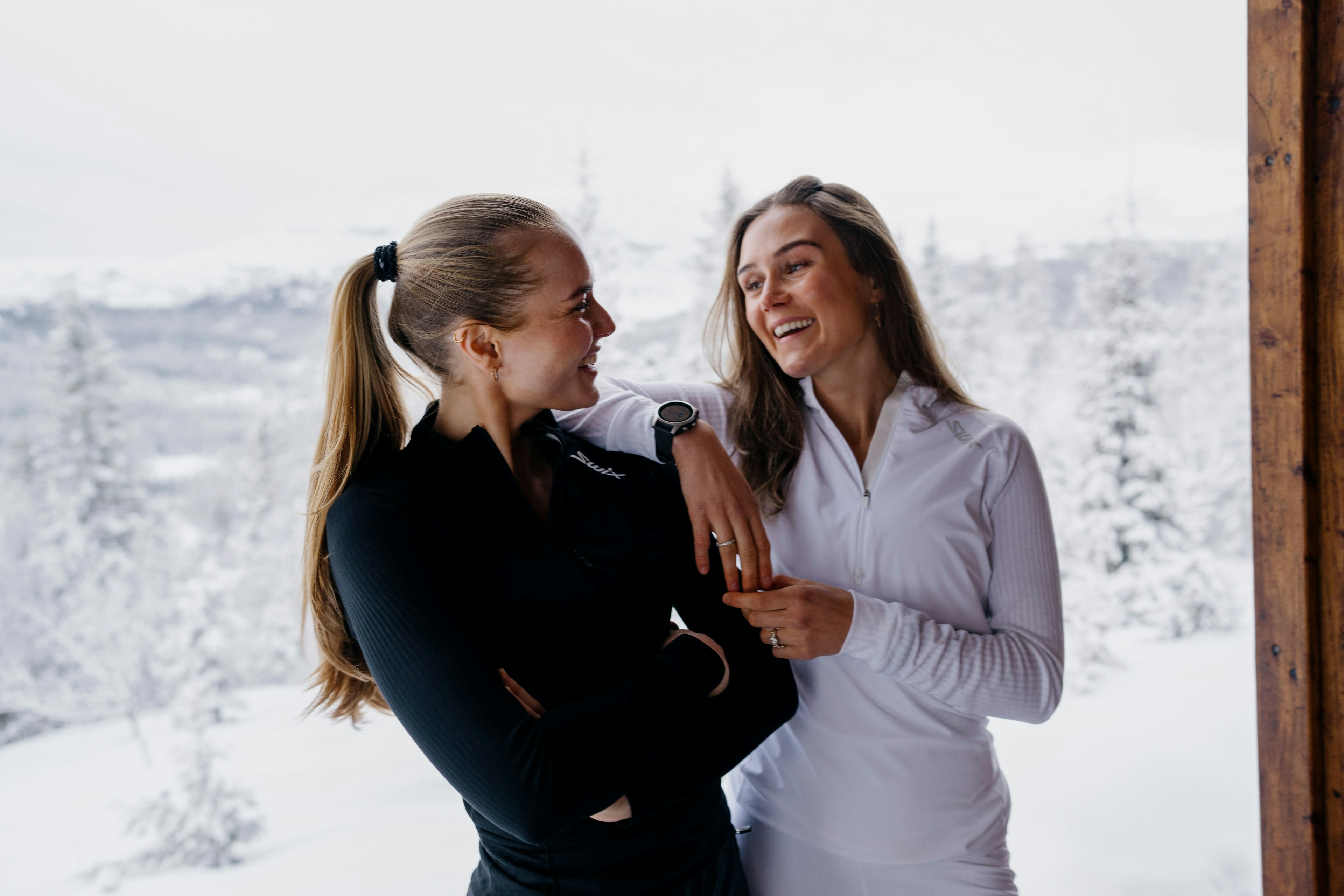 Two girls in winter environment with Swix Racex clothing 