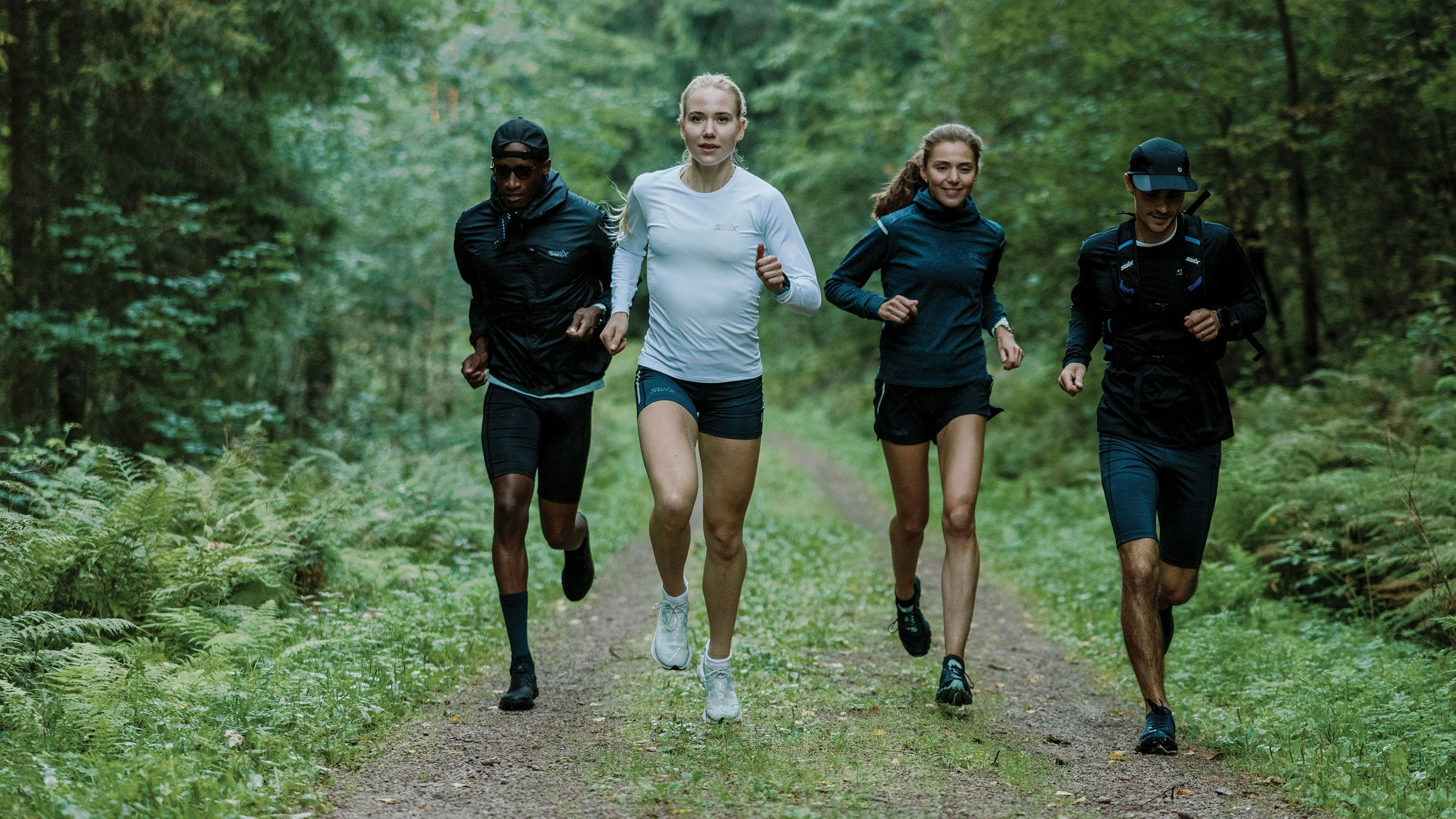 A group of people running in the woods