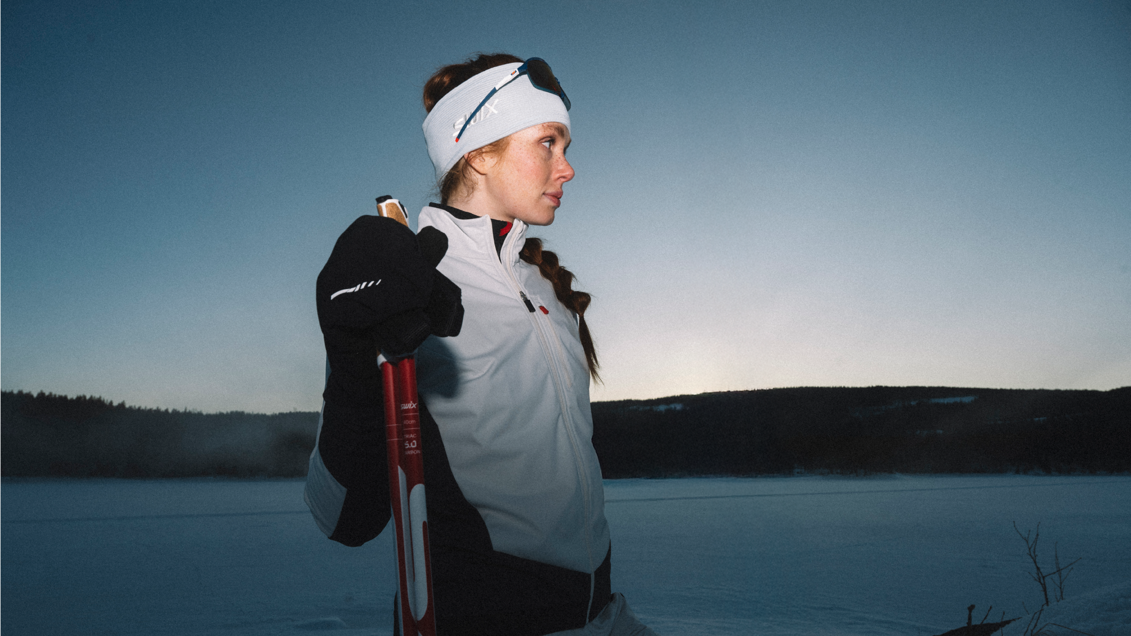 Woman skiing in the forest at twilight (desktop)