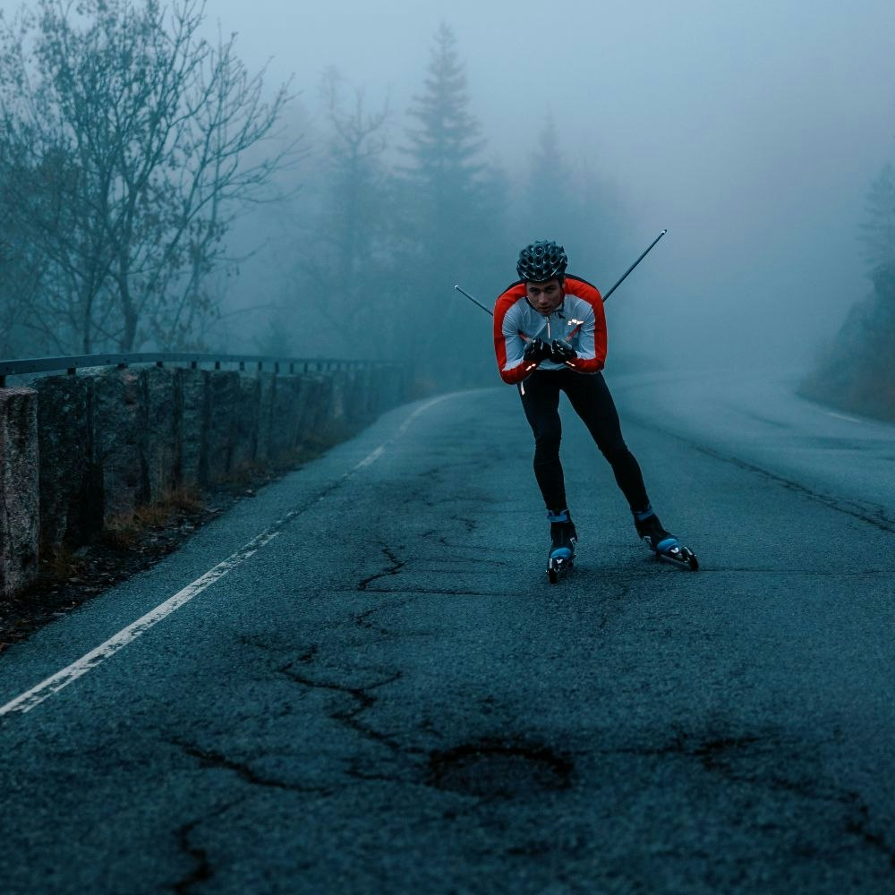 Person roller skiing during fall downhill